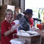 Steinger, Greene & Feiner gets to work, assembling meals as part of the 2009 Big Heart Brigade.