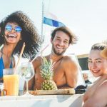 group-of-happy-friends-drinking-tropical-cocktails-at-boat-party-picture-id937868764-1