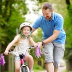 happy-father-teaching-his-little-daughter-to-ride-a-bicycle-child-to-picture-id938635616-1-e1552405720276