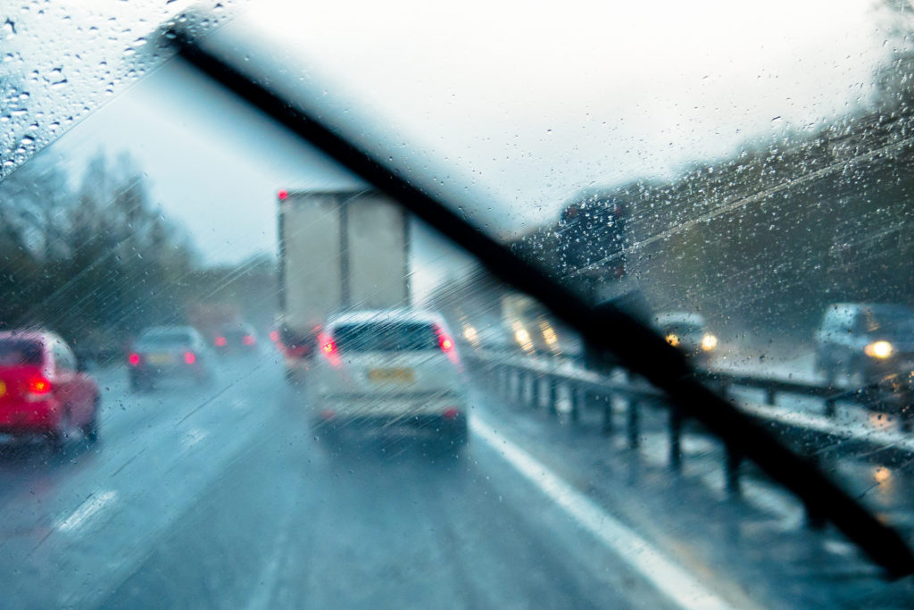 Rain through the window of a car on a motorway