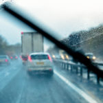 Rain through the window of a car on a motorway