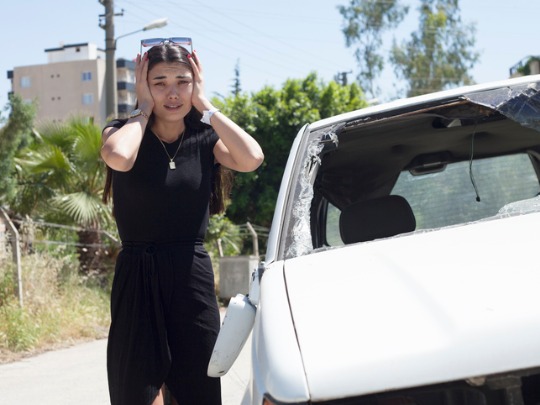 woman looks distressed after car accident