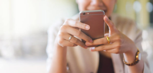 woman using social media on her phone