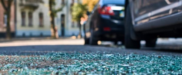 Sharp shards of car glass on the asphalt