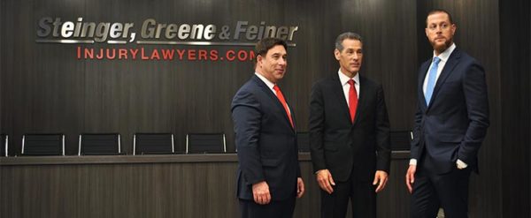 Steinger, Greene & Feiner standing in court room