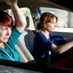 two women bracing for a car crash accident