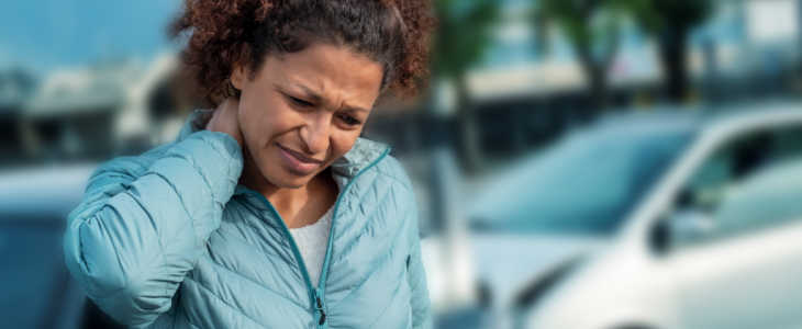 Woman suffering whiplash after bad cars pile up