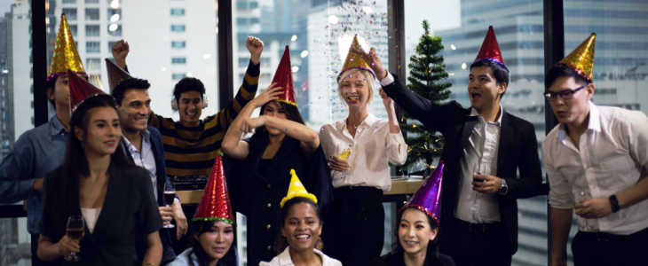 Close-up smiling Businesspeople on New Year Party in Office and celebrating of New Year small group.