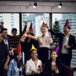 Close-up smiling Businesspeople on New Year Party in Office and celebrating of New Year small group.