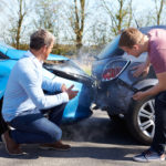 fender bender with two men looking at the damage.