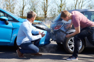 fender bender with two men looking at the damage.