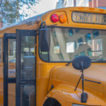 Opened doors in yellow school bus.