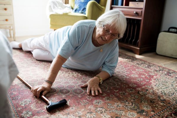 senior woman on teh ground after slipping at nursing home