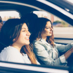 Girl is driving a car with her girls friends